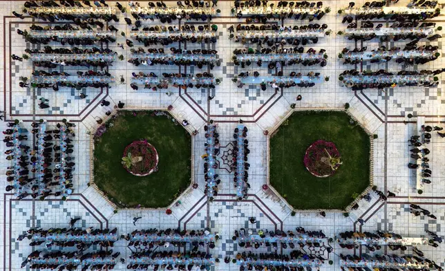 Shiites break their fast during the Islamic holy month of Ramadan in the Imam Ali shrine in Najaf, Iraq, Friday, March 21, 2025. (AP Photo/Anmar Khalil)