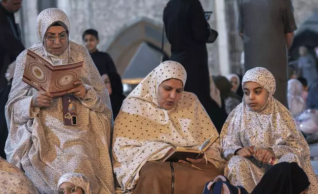 Sunni women read the Quran during Laylat al-Qadr, or the Night of Destiny, in the holy Sunni shrine of Abdul-Qadir al-Gailani, in the holy fasting month of Ramadan, in Baghdad, Iraq, Wednesday, March 26, 2025. (AP Photo/Hadi Mizban)