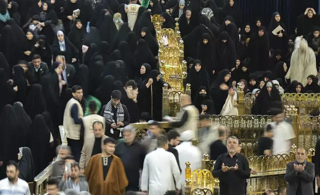 Shiite Muslim pilgrims visit the holy shrine of Imam Abbas during Laylat al-Qadr, or the Night of Destiny, in the holy fasting month of Ramadan in Karbala, Iraq, Sunday, March 23, 2025. (AP Photo/Hadi Mizban)