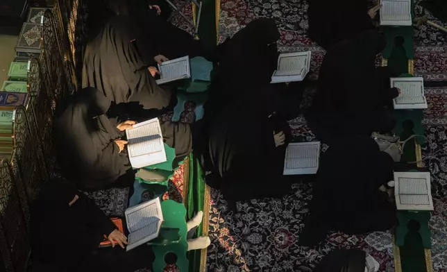 Shiites read the Quran at the shrine of Imam Abbas during the holy month of Ramadan in Karbala, Iraq, Wednesday, March 12, 2025. (AP Photo/Hadi Mizban)
