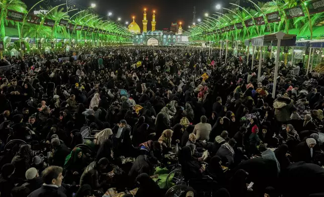 Shiite Muslim pilgrims visit the holy shrine of Imam Abbas during Laylat al-Qadr, or the Night of Destiny, during the holy fasting month of Ramadan in Karbala, Iraq, Sunday, March 23, 2025. (AP Photo/Hadi Mizban)
