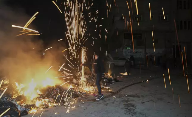 A boy plays with a firecracker after Iftar, the meal that breaks the fast during Ramadan, in Gaza City, Thursday, March 6, 2025. (AP Photo/Abdel Kareem Hana)