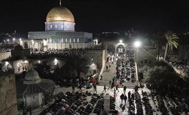 Palestinian Muslim worshippers pray during Laylat Al Qadr, also known as the Night of Power and marked on the 27th day of the holy fasting month of Ramadan, in front of the Dome of the Rock shrine at the Al-Aqsa Mosque compound in the Old City of Jerusalem, Wednesday, March 26, 2025. (AP Photo/Mahmoud Illean)