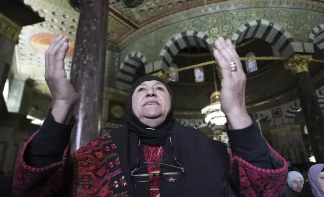 A woman prays at the Al-Aqsa Mosque compound during the first Friday Prayers of the Muslim holy month of Ramadan in the Old City of Jerusalem, Friday, March 7, 2025. (AP Photo/Mahmoud Illean)