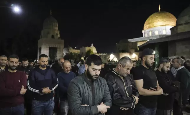 Palestinian Muslim worshippers pray during Laylat Al Qadr, also known as the Night of Power and marked on the 27th day of the holy fasting month of Ramadan, in front of the Dome of the Rock shrine at the Al-Aqsa Mosque compound in the Old City of Jerusalem, Wednesday, March 26, 2025. (AP Photo/Mahmoud Illean)