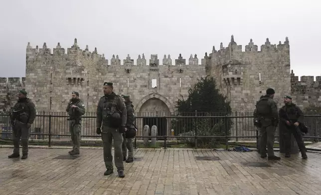 Israeli Border Police stand guard at the Damascus Gate to the Old City of Jerusalem as worshippers make their way to the Al-Aqsa Mosque compound for the first Friday Prayers of the Muslim holy month of Ramadan, Friday, March 7, 2025. (AP Photo/Mahmoud Illean)