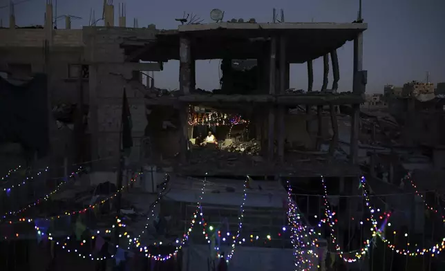 Palestinians hang decorations next to their destroyed homes in preparation for the holy month of Ramadan in Khan Younis, southern Gaza Strip, Friday, Feb. 28, 2025. (AP Photo/Jehad Alshrafi)