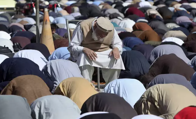 Muslims attend first Friday prayers during the Muslim holy fasting month of Ramadan, at outer area of a mosque, in Peshawar, Pakistan, Friday, March 7, 2025. (AP Photo/Muhammad Sajjad)