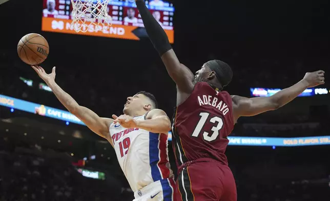 Detroit Pistons forward Simone Fontecchio (19) drives to the basket as Miami Heat center Bam Adebayo (13) defends during the first half of an NBA basketball game, Wednesday, March 19, 2025, in Miami. (AP Photo/Marta Lavandier)