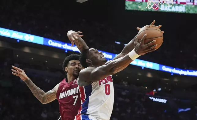 Miami Heat center Kel'el Ware (7) fouls Detroit Pistons center Jalen Duren (0) as he drives to the basket during the first half of an NBA basketball game, Wednesday, March 19, 2025, in Miami. (AP Photo/Marta Lavandier)