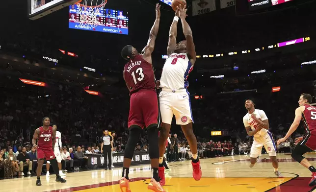 Detroit Pistons center Jalen Duren (0) aims to score as Miami Heat center Bam Adebayo (13) defends during the first half of an NBA basketball game, Wednesday, March 19, 2025, in Miami. (AP Photo/Marta Lavandier)