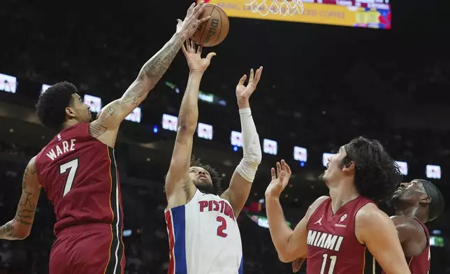Miami Heat center Kel'el Ware (7) blocks a shot to the basket by Detroit Pistons guard Cade Cunningham (2) during the first half of an NBA basketball game, Wednesday, March 19, 2025, in Miami. (AP Photo/Marta Lavandier)