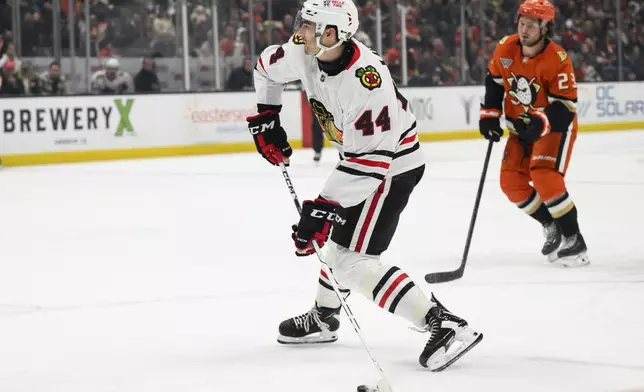 Chicago Blackhawks defenseman Wyatt Kaiser shoots and scores during the second period of an NHL hockey game against the Anaheim Ducks, Saturday, March 1, 2025, in Anaheim, Calif. (AP Photo/William Liang)