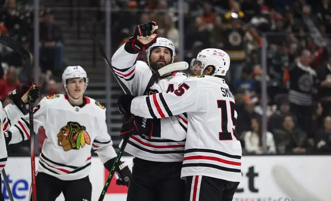 Chicago Blackhawks left wing Patrick Maroon, center, gestures after scoring a goal during the second period of an NHL hockey game against the Anaheim Ducks, Saturday, March 1, 2025, in Anaheim, Calif. (AP Photo/William Liang)