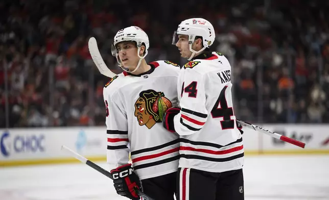 Chicago Blackhawks center Teuvo Teravainen, left, celebrates after his goal with defenseman Wyatt Kaiser, right, during the second period of an NHL hockey game against the Anaheim Ducks, Saturday, March 1, 2025, in Anaheim, Calif. (AP Photo/William Liang)