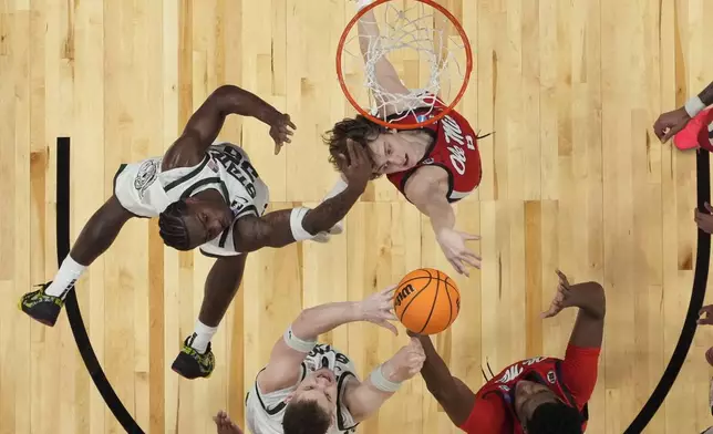 Mississippi guard Eduardo Klafke (8) and Michigan State forward Coen Carr (55) vie for a loose ball during the first half in the Sweet 16 of the NCAA college basketball tournament, Friday, March 28, 2025, in Atlanta. (AP Photo/George Walker IV)