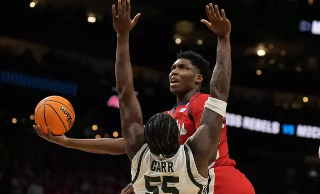 Mississippi forward Malik Dia (0) shoots against Michigan State forward Coen Carr (55) during the first half in the Sweet 16 of the NCAA college basketball tournament, Friday, March 28, 2025, in Atlanta. (AP Photo/George Walker IV)