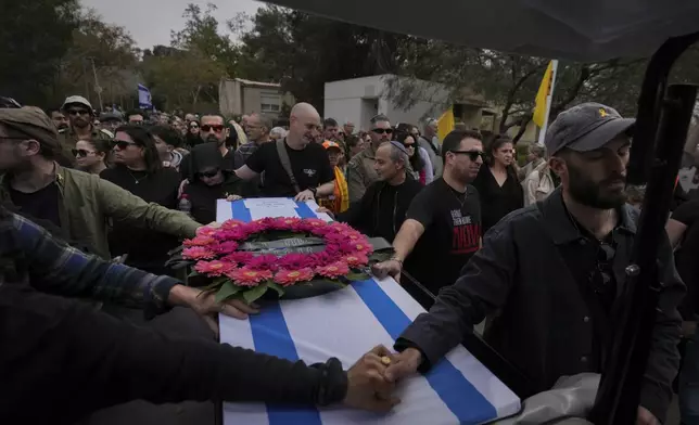 Mourners carry the coffin of Itzhak Elgarat, a slain hostage who was held captive by Hamas in Gaza, during his funeral procession in Kibbutz Nir Oz, Israel, on Monday, March 3, 2025. (AP Photo/Ohad Zwigenberg)