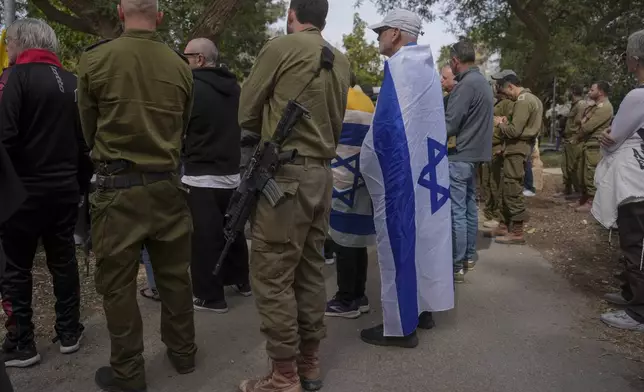 Mourners attend the funeral of Itzhak Elgarat, a slain hostage who was held captive by Hamas in Gaza, in Kibbutz Nir Oz, Israel, on Monday, March 3, 2025. (AP Photo/Ohad Zwigenberg)