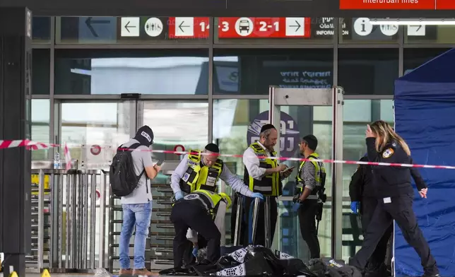 Israeli rescue and security forces examine the scene of a stabbing attack in Haifa, Israel, on Monday, March 30, 2025, where a 70-year-old man was killed and four others were injured. (AP Photo/Ariel Schalit)