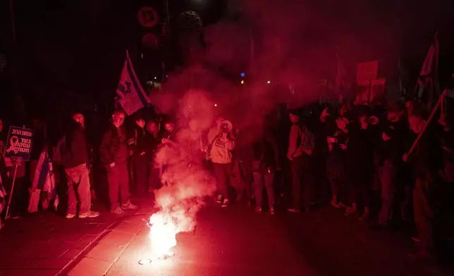 Israelis take part in a protest against Israeli Prime Minister Benjamin Netanyahu's government, and the release of the hostages held in the Gaza Strip by the Hamas militant group, in Jerusalem, Sunday, March 2, 2025. (AP Photo/Ohad Zwigenberg)