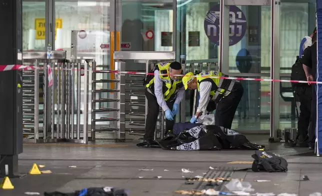 Israeli rescue and security forces examine the scene of a stabbing attack in Haifa, Israel, on Monday, March 30, 2025, where a 70-year-old man was killed and four others were injured. (AP Photo/Ariel Schalit)