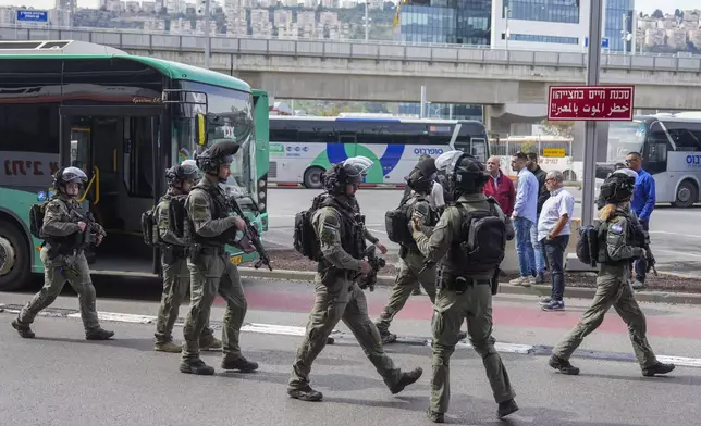 Israeli security forces secure the scene of a stabbing attack in Haifa, Israel, on Monday, March 30, 2025, where a 70-year-old man was killed and four others were injured. (AP Photo/Ariel Schalit)