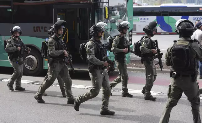 Israeli security forces secure the scene of a stabbing attack in Haifa, Israel, on Monday, March 30, 2025, where a 70-year-old man was killed and four others were injured. (AP Photo/Ariel Schalit)