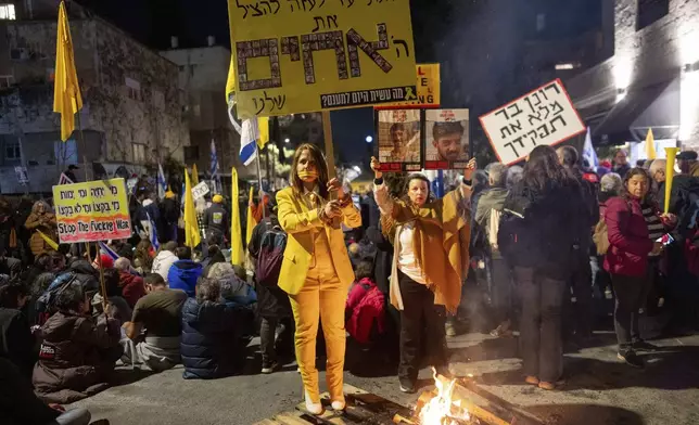 Israelis take part in a protest against Israeli Prime Minister Benjamin Netanyahu's government, and the release of the hostages held in the Gaza Strip by the Hamas militant group, in Jerusalem,Sunday, March 2, 2025. (AP Photo/Ohad Zwigenberg)