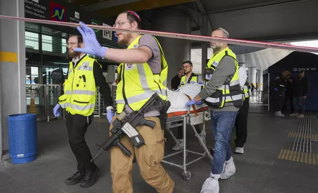 Members of ZAKA rescue services carry the body of a 70-year-old killed in stabbing attack in Haifa, Israel, on Monday, March 30, 2025. Four others were also injured in the incident. (AP Photo/Ariel Schalit)
