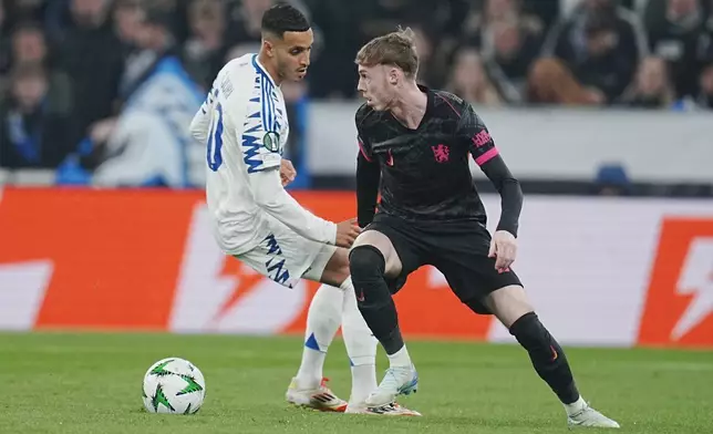 Copenhagen's Elias Achouri, left, and Chelsea's Cole Palmer in action during the Conference League round of 16 soccer match between FC Copenhagen and Chelsea FC at Parken Stadium in Copenhagen, Denmark, Thursday March 6, 2025. (Liselotte Sabroe/Ritzau Scanpix via AP)