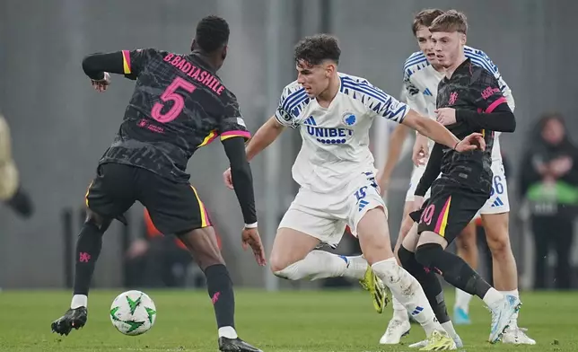 Copenhagen's Amin Chiakha in action with Chelsea's Benoit Badiashile, left, and Cole Palmer during the Conference League round of 16 soccer match between FC Copenhagen and Chelsea FC at Parken Stadium in Copenhagen, Denmark, Thursday March 6, 2025. (Liselotte Sabroe/Ritzau Scanpix via AP)