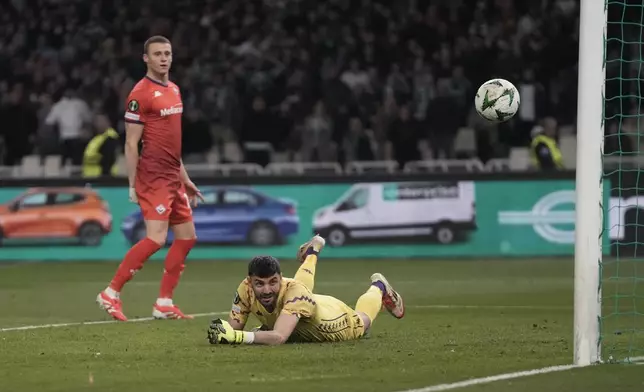 Fiorentina's goalkeeper Pietro Terracciano looks on as the ball hits the bar during the Europa Conference League round of 16 first leg soccer match between Panathinaikos and Fiorentina at the Olympic stadium in Athens, Greece, Thursday, March 6, 2025. (AP Photo/Thanassis Stavrakis)