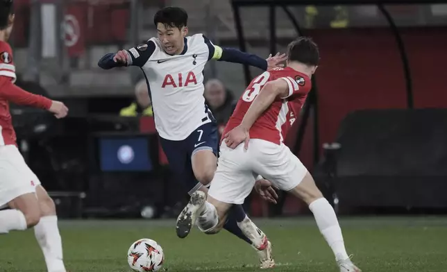 Tottenham's Son Heung-min, left, challenges for the ball with AZ Alkmaar's Wouter Goes during the Europa League round of 16 first leg match between AZ and Tottenham at AFAS Stadium, in Alkmaar, in Alkmaar, Netherlands , Thursday, March 6, 2025. (AP Photo/Patrick Post)