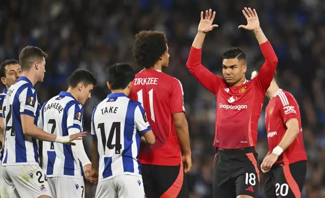 Manchester United's Casemiro, right, reacts during the Europa League round of 16 first leg soccer match between Real Sociedad and Manchester United at the Reale Arena in San Sebastian, Spain, Thursday, March 6, 2025. (AP Photo/Miguel Oses)
