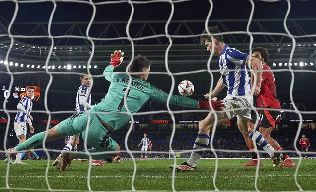Real Sociedad's goalkeeper Alex Remiro makes a save during the Europa League round of 16 first leg soccer match between Real Sociedad and Manchester United at the Reale Arena in San Sebastian, Spain, Thursday, March 6, 2025. (AP Photo/Miguel Oses)