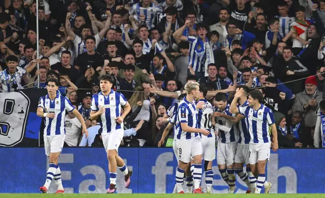 Real Sociedad players celebrate after Real Sociedad's Mikel Oyarzabal scored his side's opening goal during the Europa League round of 16 first leg soccer match between Real Sociedad and Manchester United at the Reale Arena in San Sebastian, Spain, Thursday, March 6, 2025. (AP Photo/Miguel Oses)