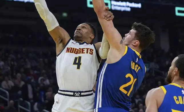 Denver Nuggets guard Russell Westbrook (4) shoots while defended by Golden State Warriors center Quinten Post (21) during the first half of an NBA basketball game Monday, March 17, 2025, in San Francisco. (AP Photo/Godofredo A. Vásquez)