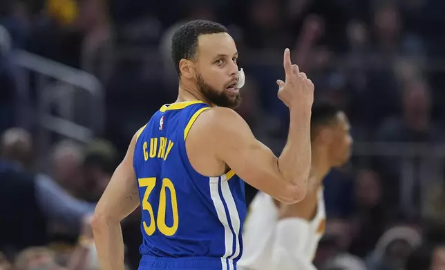 Golden State Warriors guard Stephen Curry reacts after making a 3-point basket during the first half of an NBA basketball game against the Denver Nuggets, Monday, March 17, 2025, in San Francisco. (AP Photo/Godofredo A. Vásquez)