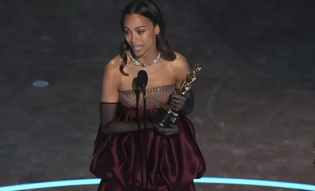 Zoe Saldana accepts the award for best performance by an actress in a supporting role for "Emilia Perez" during the Oscars on Sunday, March 2, 2025, at the Dolby Theatre in Los Angeles. (AP Photo/Chris Pizzello)