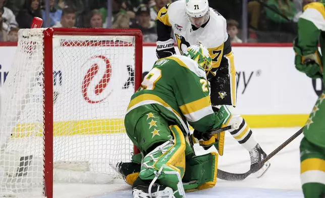 Pittsburgh Penguins center Evgeni Malkin (71) scores a power play goal on Minnesota Wild goaltender Marc-Andre Fleury (29) during the second period of an NHL hockey game, Sunday, March 9, 2025, in St. Paul, Minn. (AP Photo/Ellen Schmidt)