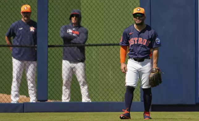 Houston Astros' Jose Altuve takes up his position in left field during the third inning of a spring training baseball game against the St. Louis Cardinals Friday, Feb. 28, 2025, in West Palm Beach, Fla. (AP Photo/Jeff Roberson)