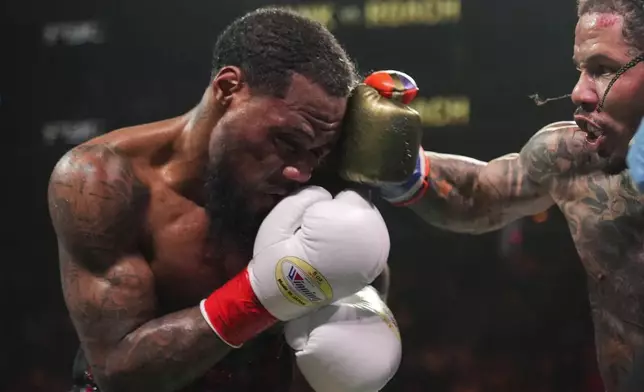 Gervonta Davis, left, punches Lamont Roach during the ninth round of a WBA lightweight championship boxing bout Sunday, March 2, 2025, in New York. (AP Photo/Frank Franklin II)
