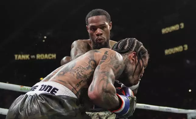 Lamont Roach, left, punches Gervonta Davis during the third round of a WBA lightweight championship boxing bout Saturday, March 1, 2025, in New York. (AP Photo/Frank Franklin II)