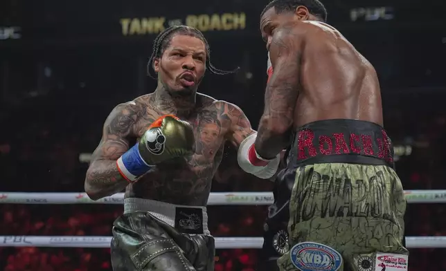 Gervonta Davis, left, punches Lamont Roach during the third round of a WBA lightweight championship boxing bout Saturday, March 1, 2025, in New York. (AP Photo/Frank Franklin II)