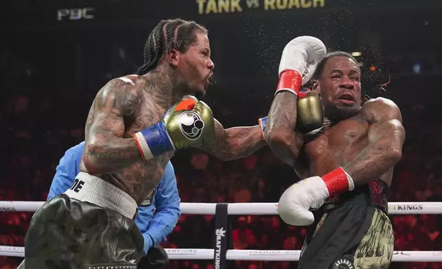 Gervonta Davis, left, punches Lamont Roach during the ninth round of a WBA lightweight championship boxing bout Sunday, March 2, 2025, in New York. (AP Photo/Frank Franklin II)