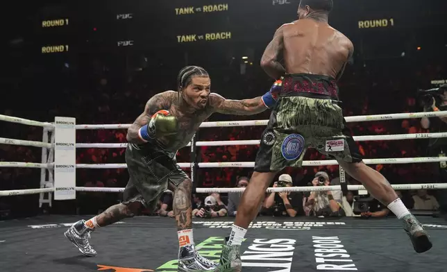 Gervonta Davis, left, punches Lamont Roachduring the first round of a WBA lightweight championship boxing bout Saturday, March 1, 2025, in New York. (AP Photo/Frank Franklin II)