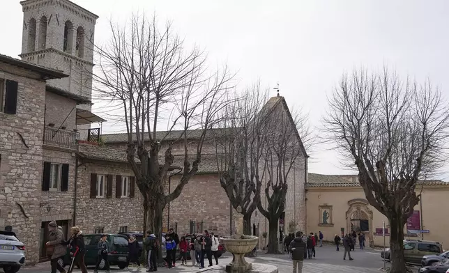 Faithful leave the the Church of Santa Maria Maggiore after visiting the tomb of 15-year-old Carlo Acutis, an Italian boy who died in 2006 of leukemia, in Assisi, Italy, on Saturday, March 1, 2025. (AP Photo/Gregorio Borgia)