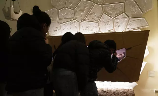 Faithful pay their homage before the tomb of 15-year-old Carlo Acutis, an Italian boy who died in 2006 of leukemia, in Assisi, Italy, on Saturday, March 1, 2025. (AP Photo/Gregorio Borgia)