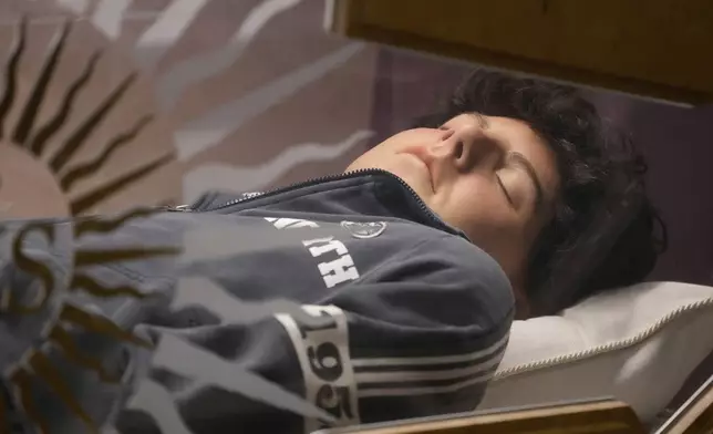 The body of Carlo Acutis, an Italian boy who died in 2006 of leukemia, lies in his tomb in Assisi, Italy, on Saturday, March 1, 2025. (AP Photo/Gregorio Borgia)